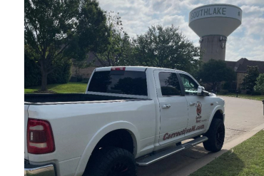 White pickup truck parked near Southlake water tower.