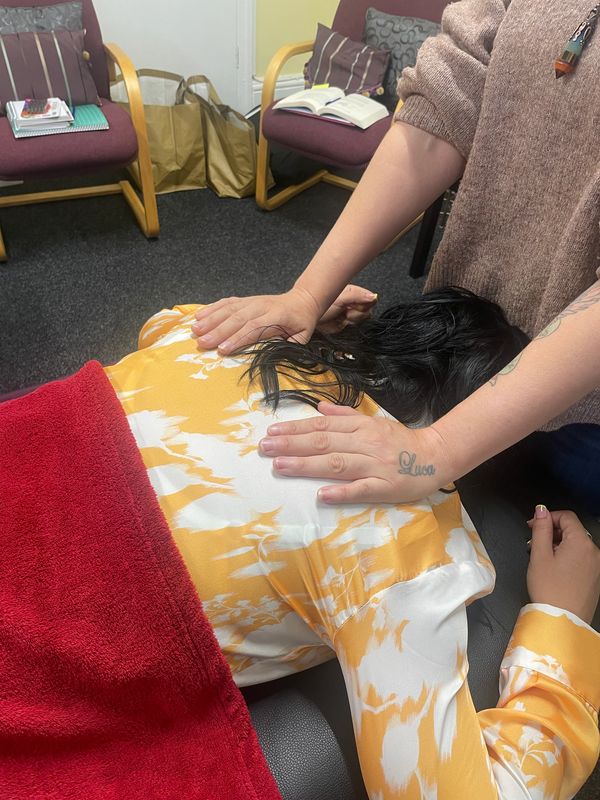 practising reiki on the back hand positions.