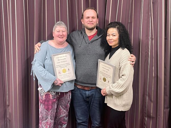reiki students after their course holding certificates of completion.