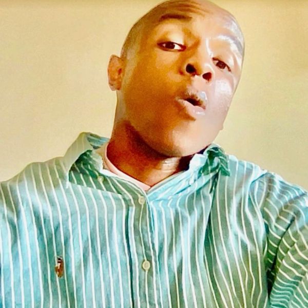 Person wearing a green striped shirt making a surprised facial expression.