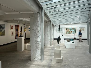 art gallery hall with original artwork and sculptures