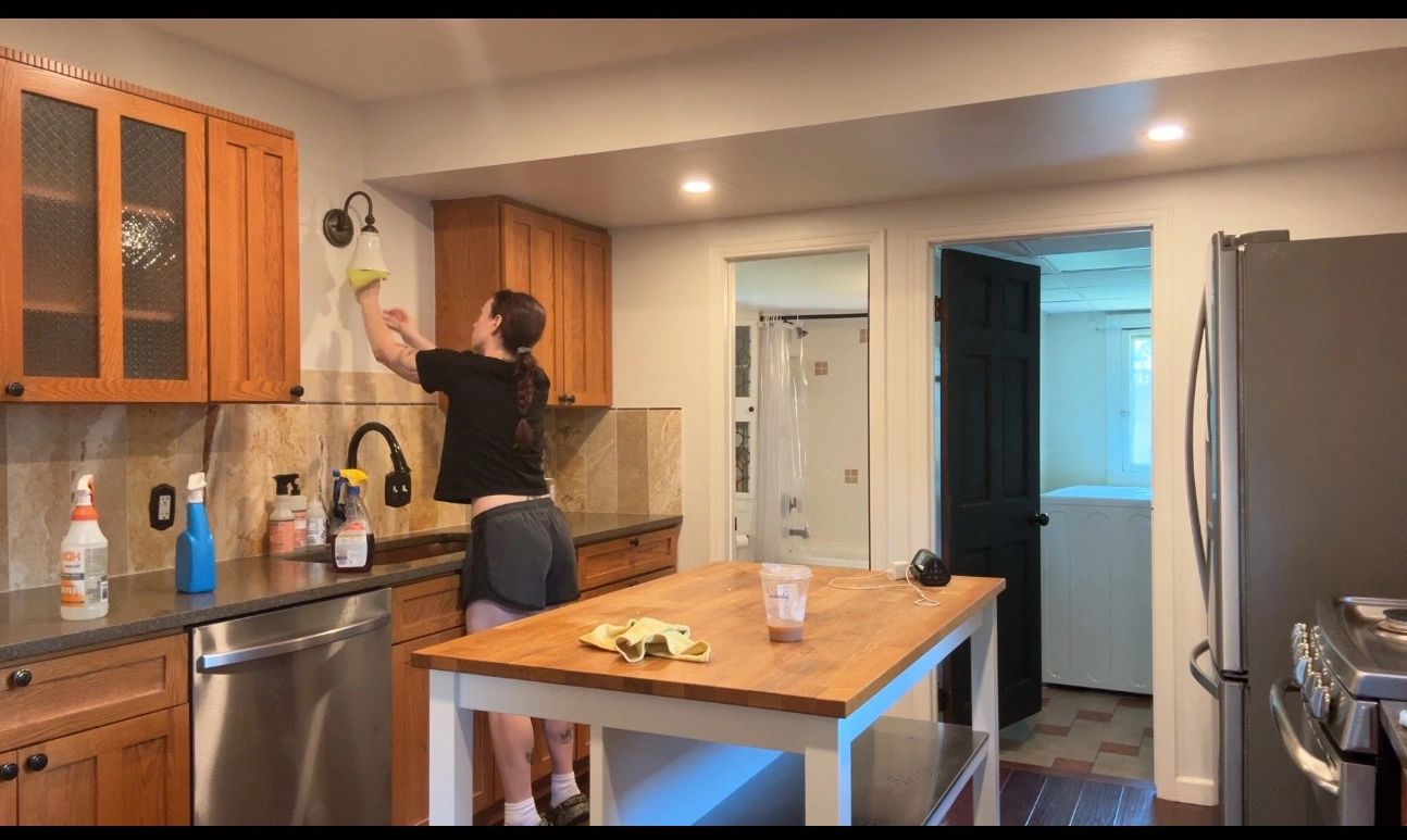 Maid for you house cleaner cleaning cabinets during a deep clean