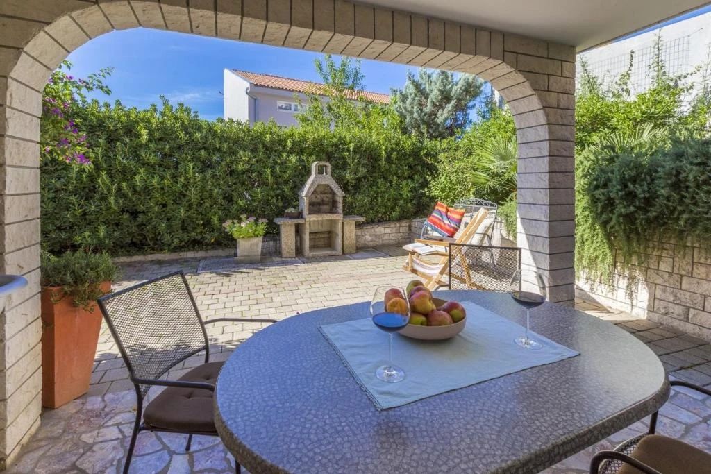 apartment with a large garden terrace and a grill