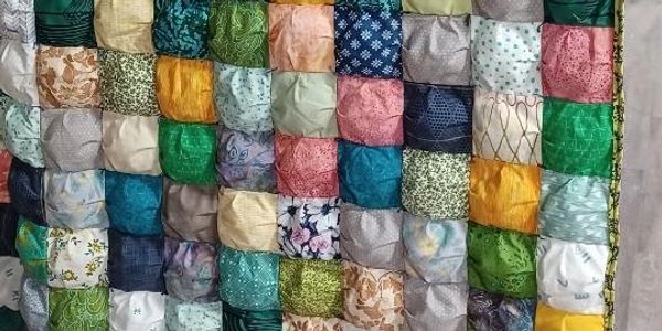 Colorful patchwork quilt with various fabric patterns.