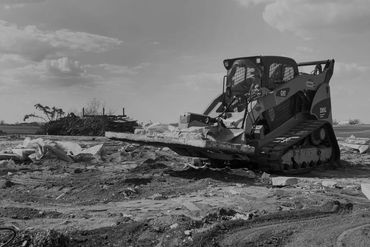 The Beak skid steer attachment carrying large concrete slabs