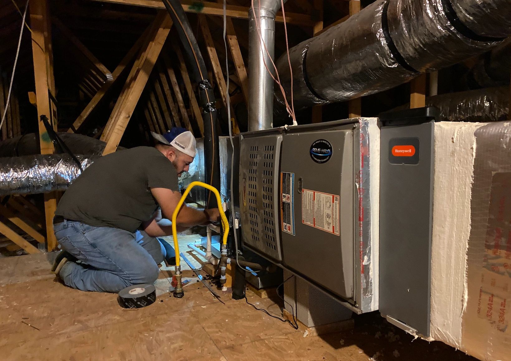 HVAC technician servicing a residential air conditioning system in Falfurrias and South Texas.