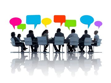 Business meeting with colorful speech bubbles.