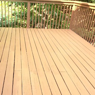 Newly painted wooden deck with fresh, warm-toned stain and Forbes Painting logo.