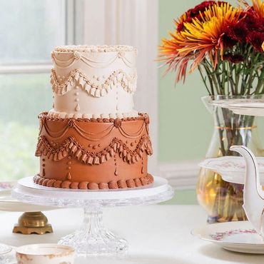 Two tier cake on a crystal pedestal cake serving plate