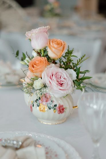 Garden party inspired tea party featuring teapot floral centerpieces.