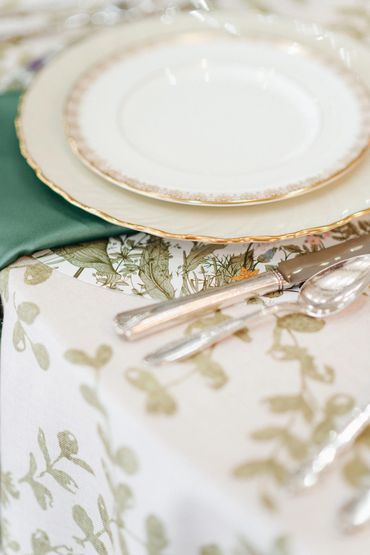 Elegant wedding reception place setting with vintage white and gold fine china in Tomball, TX