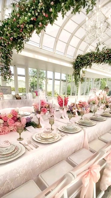 Garden conservatory set with vintage china, silverware and accessories for a lovely bridal shower.