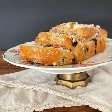 Fresh baked blueberry bread served on a vintage footed platter