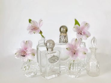 Perfume bottles used as petite bud vases for lovely bridal shower decor