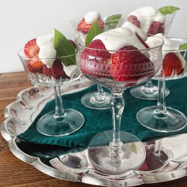 Desserts served in champagne coupe goblets on a silver platter
