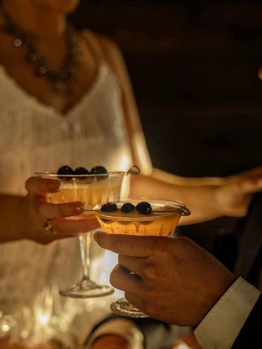 Signature cocktails served in vintage champagne coupes at an engagement party
