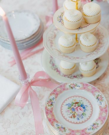 Vintage tiered dessert stand holding cupcakes for a baby shower