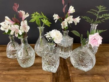 assorted decanters for use as vases for table decoration