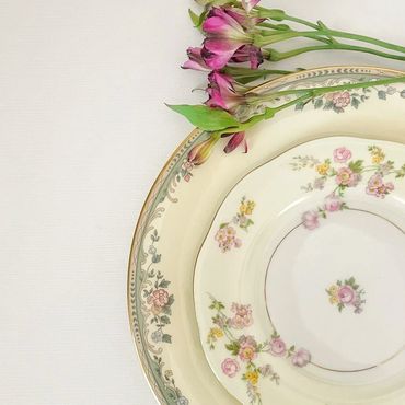Floral patterned dinner and salad plate with a side of pretty blooms.