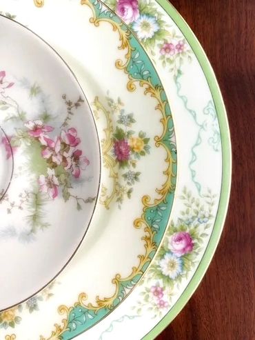 Assorted floral patterns of vintage china in shades of green and pink, perfect for a garden party.