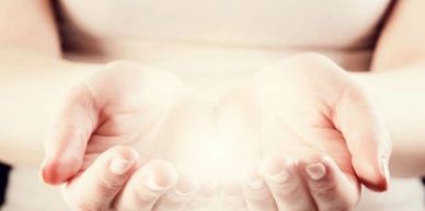 Two Palms up, together with glowing white light coming out from them