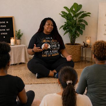 Woman leading a meditation session with a small group indoors.