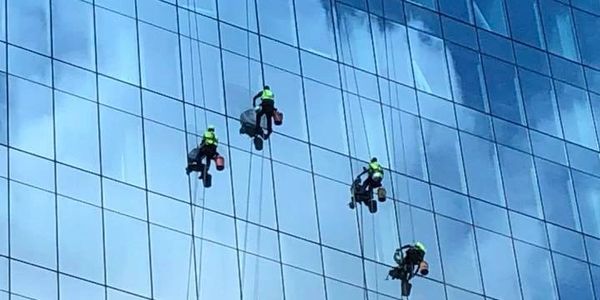 Workers washing windows in the building