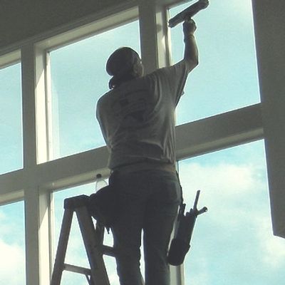 A person giving a window cleaning service