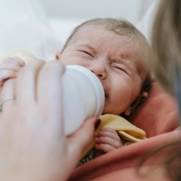 Fussy baby crying and relying on feeding to fall asleep.