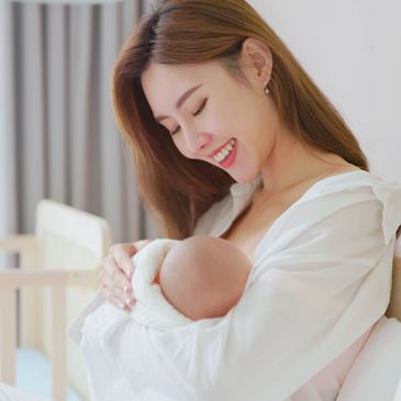 Mother taking care of well-rested baby with a predictable routine and schedule