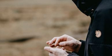 Man fiddling with something in his hands as a result of his addiction
