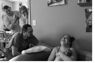 Excited family following a home waterbirth with a midwife.  "I did it!"