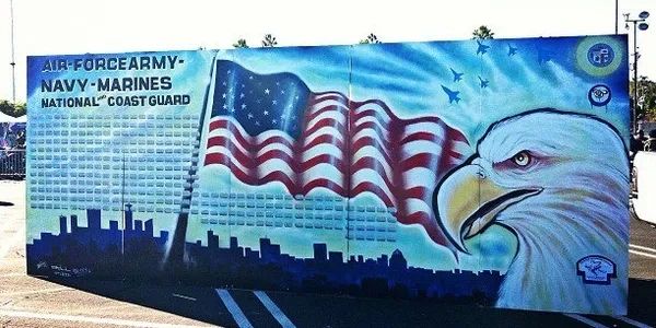 Mural featuring an American flag, eagle, and military branches.