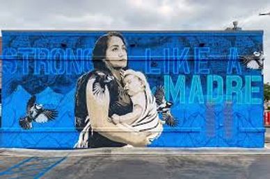 Mural of a strong mother holding her child with birds around.