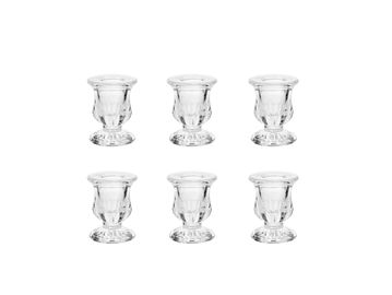 Set of six clear glass candle holders.