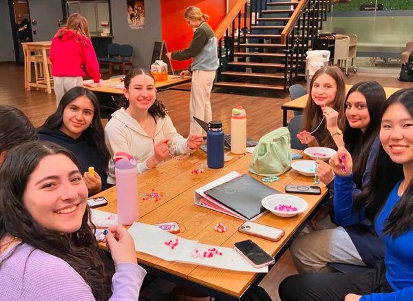 Naperville North Red Cross Club making bracelets for our kits.