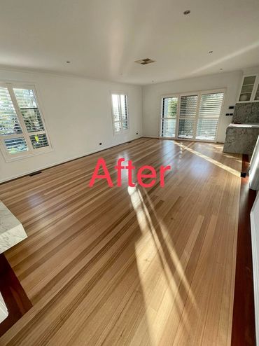 Bright, spacious room with polished wooden floors and ample natural light.