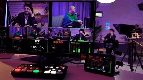 Video production control room with multiple screens and equipment.