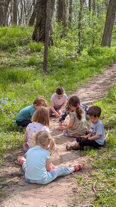 children playing in sand on a forest trail