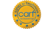 Gold seal with 'carf Accredited' and 'ASPIRE to Excellence' text.