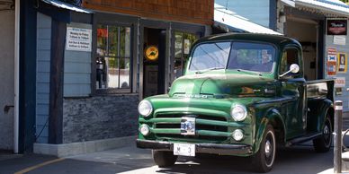 Classic green Fargo truck getting fuelled up at Shawnigan Garage in Shawnigan Lake