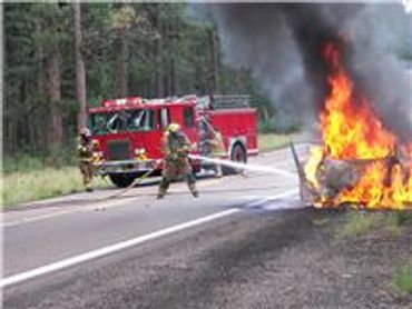 Firetruck and firemen with hoses