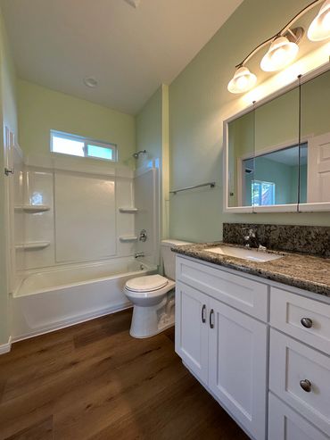 New bathroom with prefabricated tub/shower, toilet ,and vanity with granite counter Imperial Beach