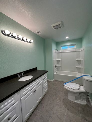 Full bathroom remodel in Alpine with new vanity, ball quartz countertops, and new fixtures