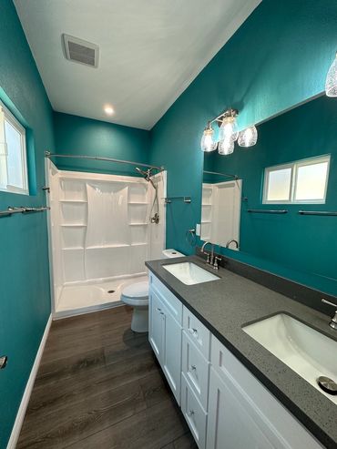 New fixtures with prefabricated shower, toilet, and vanity for College Area room addition remodel