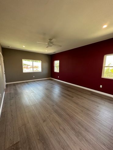 New bedroom with custom paint, flooring and trim in College Area San Diego room addition.