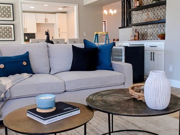 Professionally staged living room featuring coordinated furnishings, layered décor, and a welcoming layout designed to enhance comfort, functionality, and visual appeal.