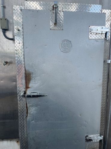 Metal diamond plate reinforcement for walk-in freezer door. With new Kason 1248 hinges and 1094 clos