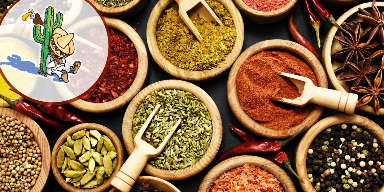 Variety of colorful spices in wooden bowls with small scoops.