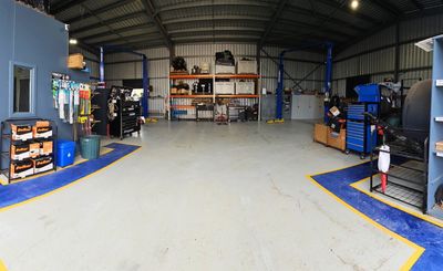 Clean and organised Mareeba workshop with hoists, tools and equipment ready for vehicle servicing.